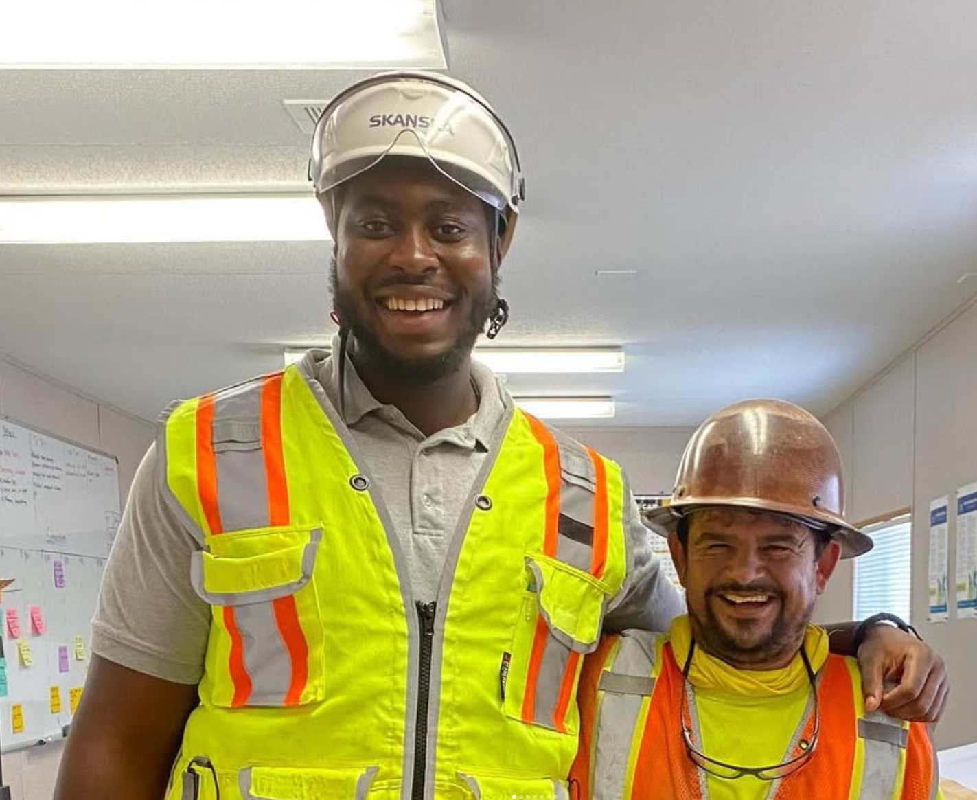 Odalo Eguabor on a construction jobsite wearing a safety vest and hard hat